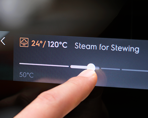 Person changing settings on steam oven 